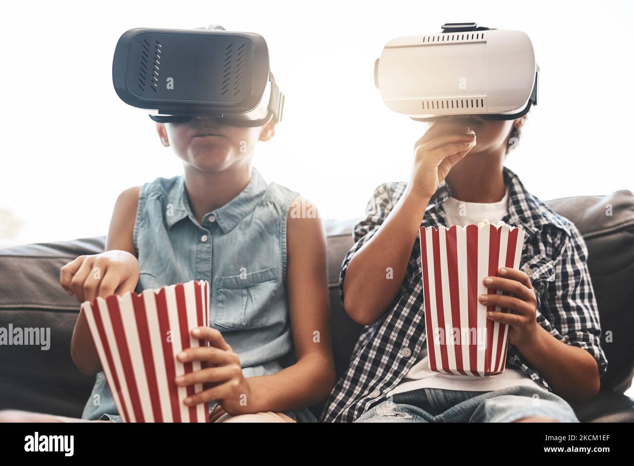 Virtually a home cinema. a brother and sister eating popcorn and