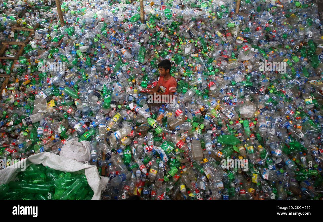A child works in a plastic bottle recycling factory in Dhaka