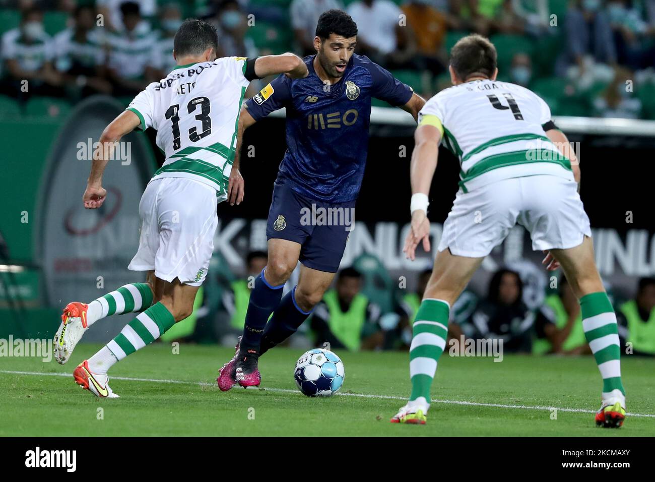 Mehdi Taremi of FC Porto (C ) vies with Luis Neto of Sporting CP (L) during the Portuguese League football match between Sporting CP and FC Porto at Jose Alvalade stadium in Lisbon, Portugal on September 11, 2021. (Photo by Pedro FiÃºza/NurPhoto) Stock Photo