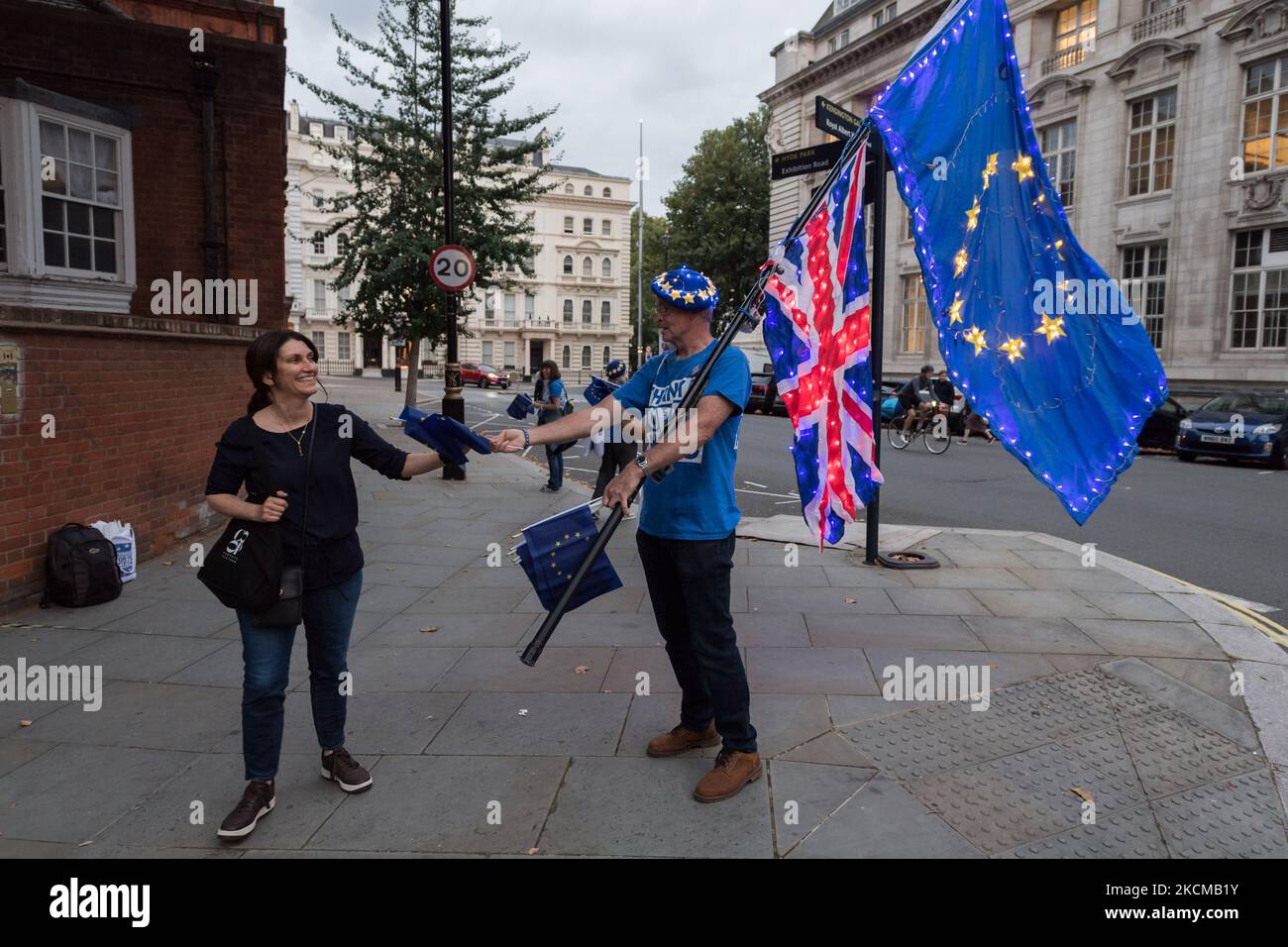 LONDON, UNITED KINGDOM - SEPTEMBER 11, 2021: Pro-EU activists hand out flags to concert-goers outside Royal Albert Hall ahead of the Last Night of the Proms to highlight lack of post-Brexit agreement for touring arts on September 11, 2021 in London, England. The campaigners call for the government to introduce a transitional support package to cover the additional post-Brexit expenses before securing an EU-wide touring artists visa waiver. (Photo by WIktor Szymanowicz/NurPhoto) Stock Photo