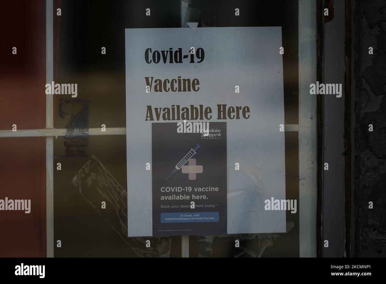 The Covid 19 Vaccine Available Here Sign Seen On The Front Door Of An the-covid-19-vaccine-available-here-sign-seen-on-the-front-door-of-an
