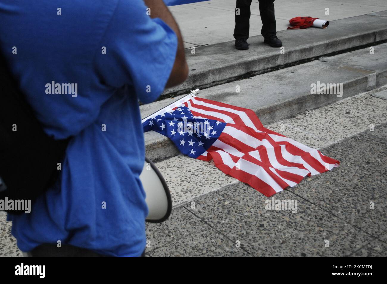 An upside-down American flag lays at the feet of activists as a former Occupier talks about systemic economic inequality, the need for electoral reforms, proportional representation, and the danger America faces moving forward if we don't make those changes during a rally in front of City Hall in Philadelphia, PA, on September 17, 2021. (Photo by Cory Clark/NurPhoto) Stock Photo