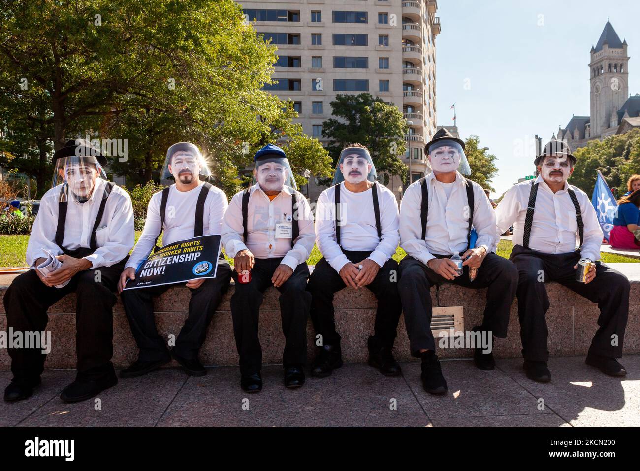 A group of men dressed as mimes await the beginning of a march for permanent residency for immigrants with temporary protected status in the US. They are part of a group acting out scenes of family separation as a result of US immigration policies. Protesters are pressuring Congress to include permanent status for TPS holders, Dreamers, temporary workers, and essential workers in the budget reconciliation bill currently underway consideration. This task has taken on greater urgency since the Senate parliamentarian’s recommendation that residency and citizenship be excluded from the bill. (Phot Stock Photo