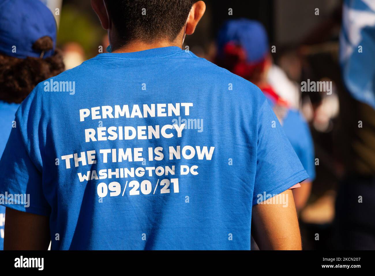 A man wears a shirt made for a march for permanent residency for immigrants with temporary protected status in the US. Protesters are pressuring Congress to include permanent status for TPS holders, Dreamers, temporary workers, and essential workers in the budget reconciliation bill currently underway consideration. This task has taken on greater urgency since the Senate parliamentarian’s recommendation that residency and citizenship be excluded from the bill. (Photo by Allison Bailey/NurPhoto) Stock Photo
