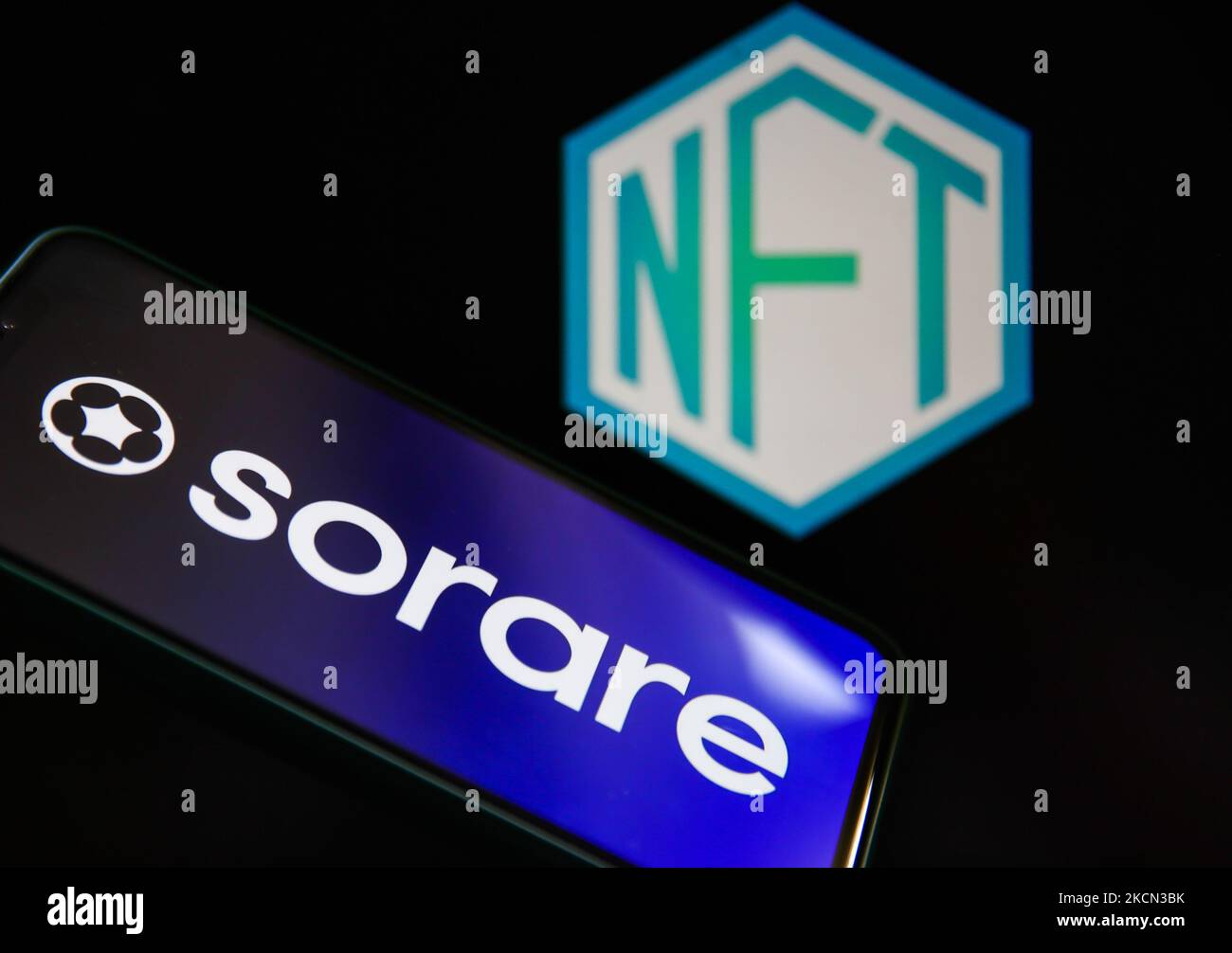 Sorare logo displayed on a phone screen and NFT logo displayed on a laptop screen are seen in this illustration photo taken in Krakow, Poland on September 21, 2021. (Photo by Jakub Porzycki/NurPhoto) Stock Photo
