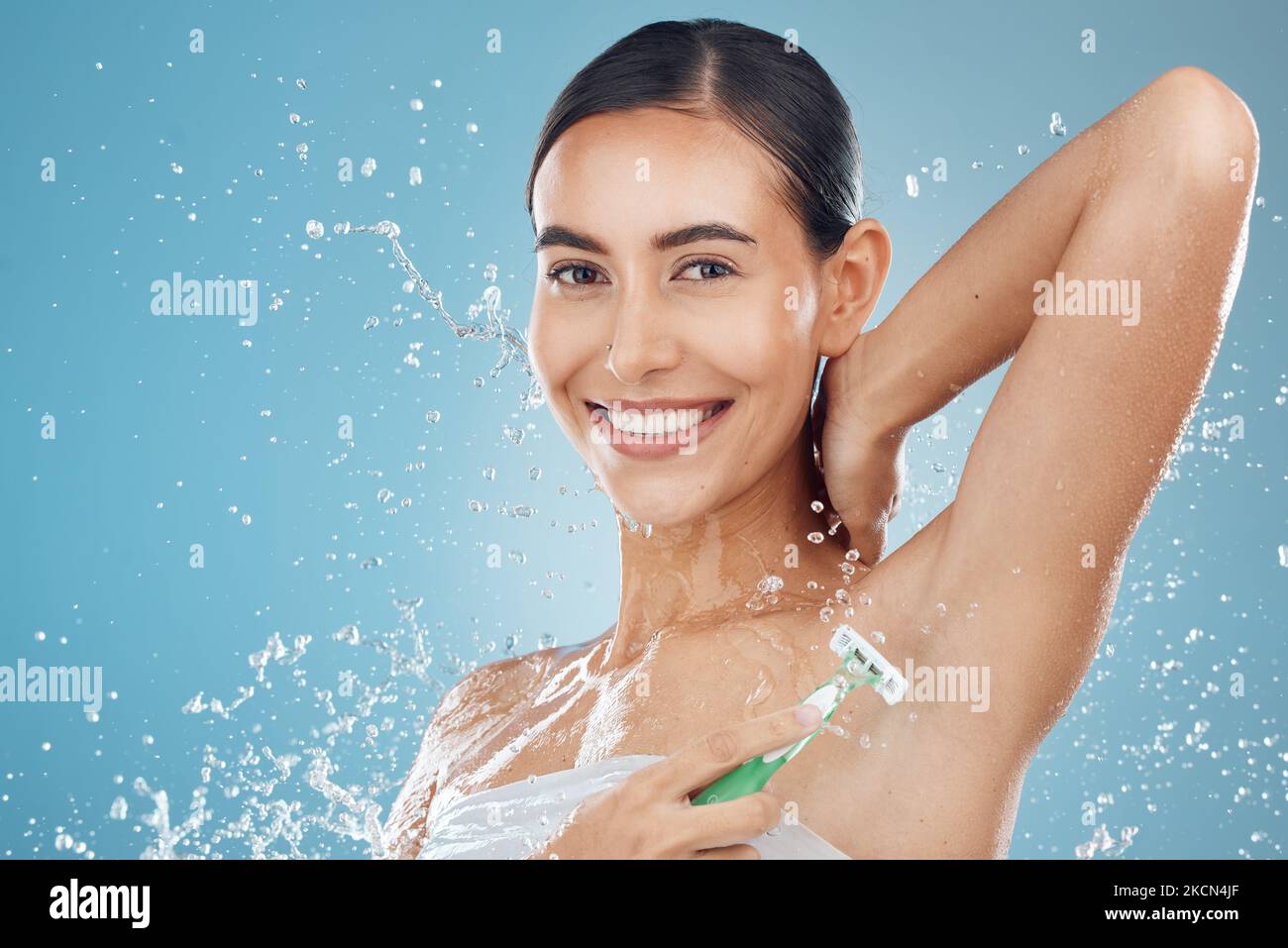 Studio, portrait and woman shaving armpit with a razor blade for hair