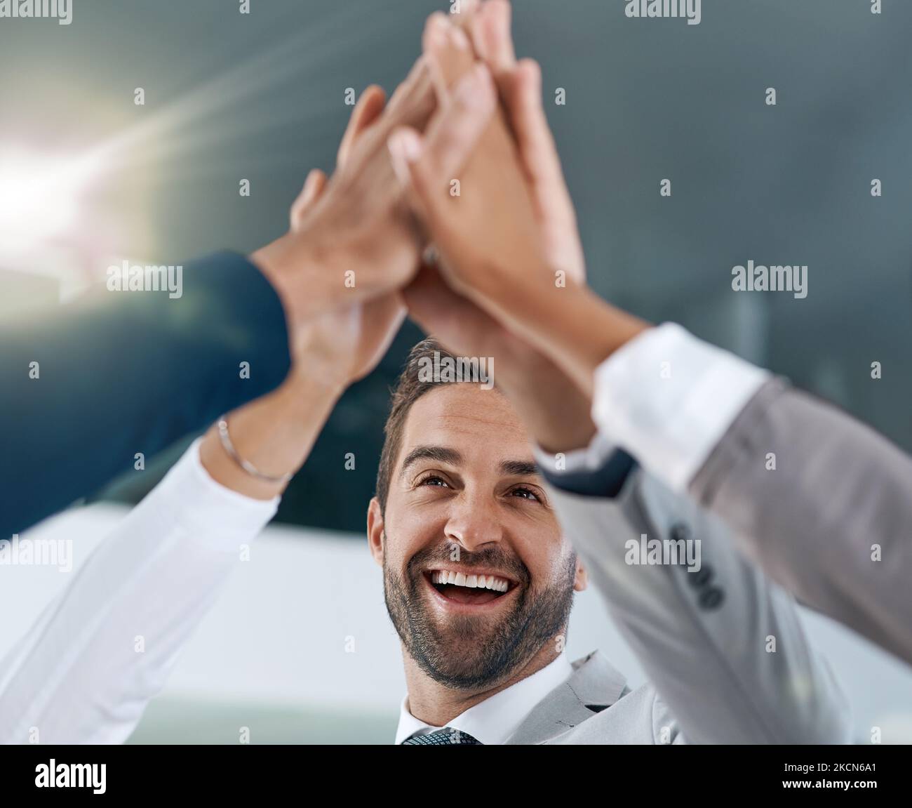 We stand together to make big changes. motivated work colleagues smiling and celebrating with a