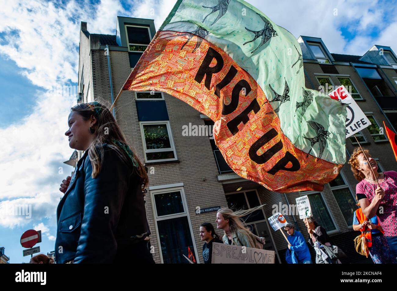 A woman is holding a flag of the climate group Extinction Rebellion, during the Global Climate Strike organized in Utrecht, on September 24th, 2021. (Photo by Romy Arroyo Fernandez/NurPhoto) Stock Photo