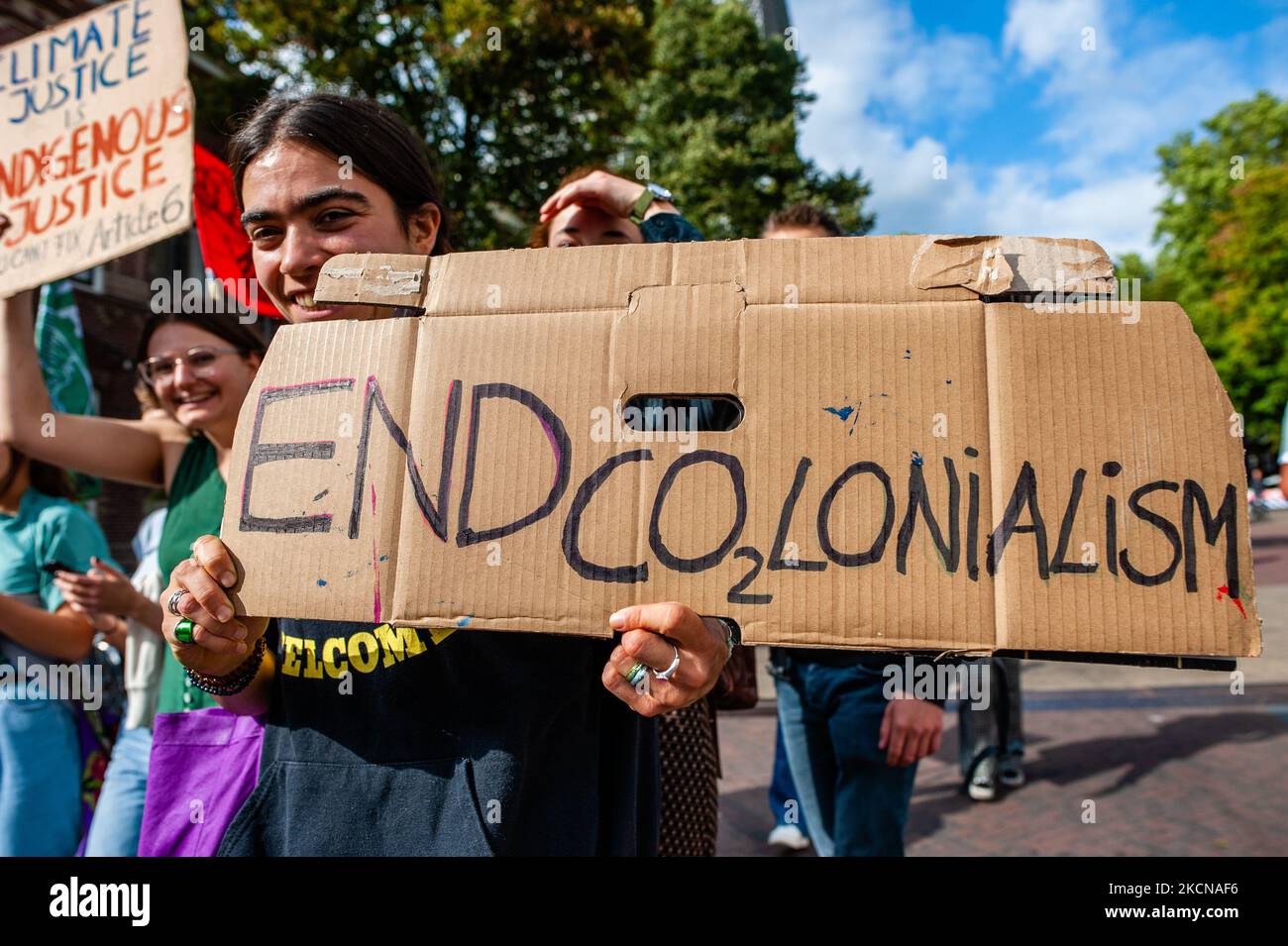 A woman is holding a placard against colonialism, during the Global Climate Strike organized in Utrecht, on September 24th, 2021. (Photo by Romy Arroyo Fernandez/NurPhoto) Stock Photo