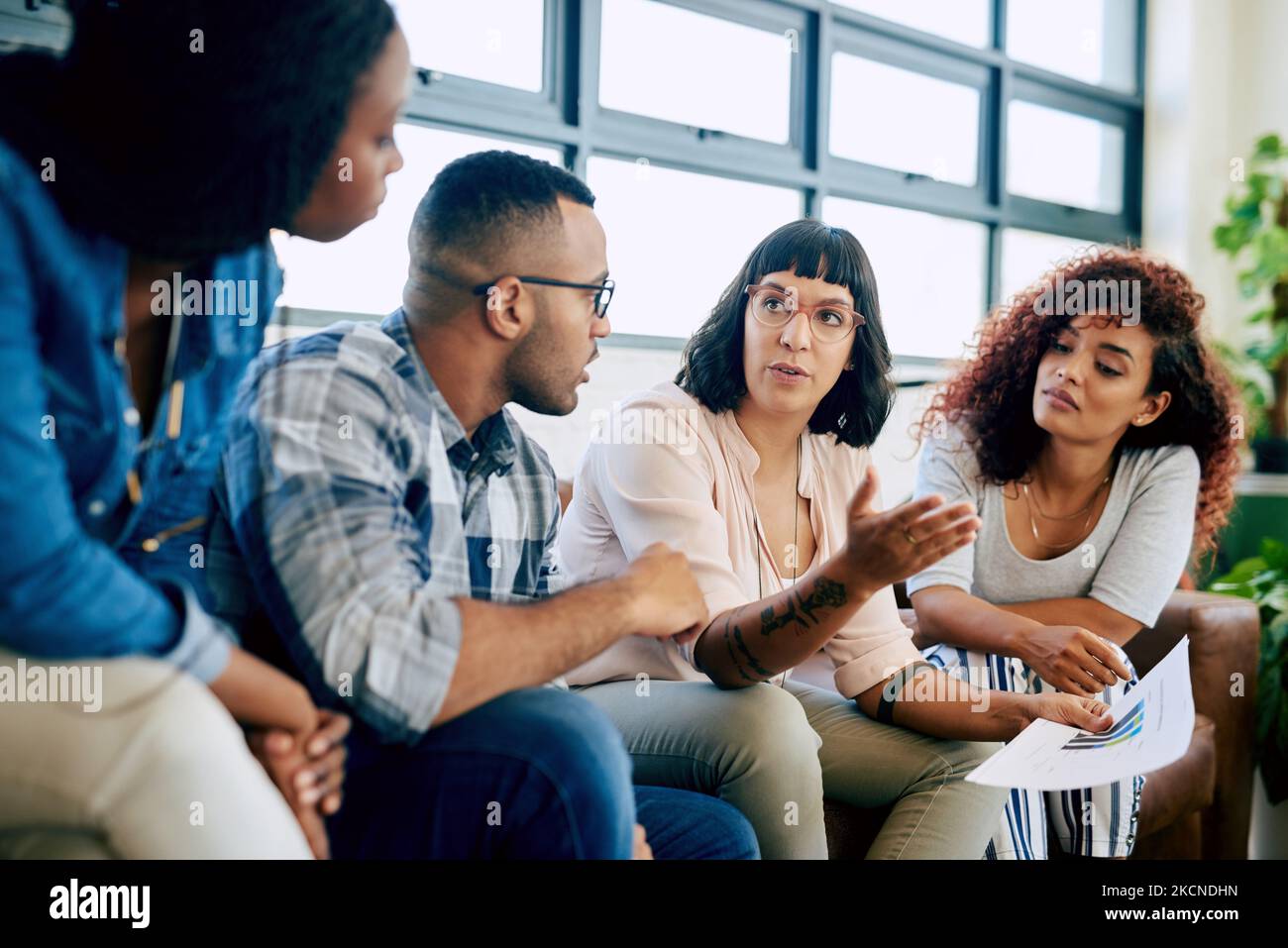 Collaborative geniuses doing what they do. a group of colleagues collaborating in a modern office. Stock Photo