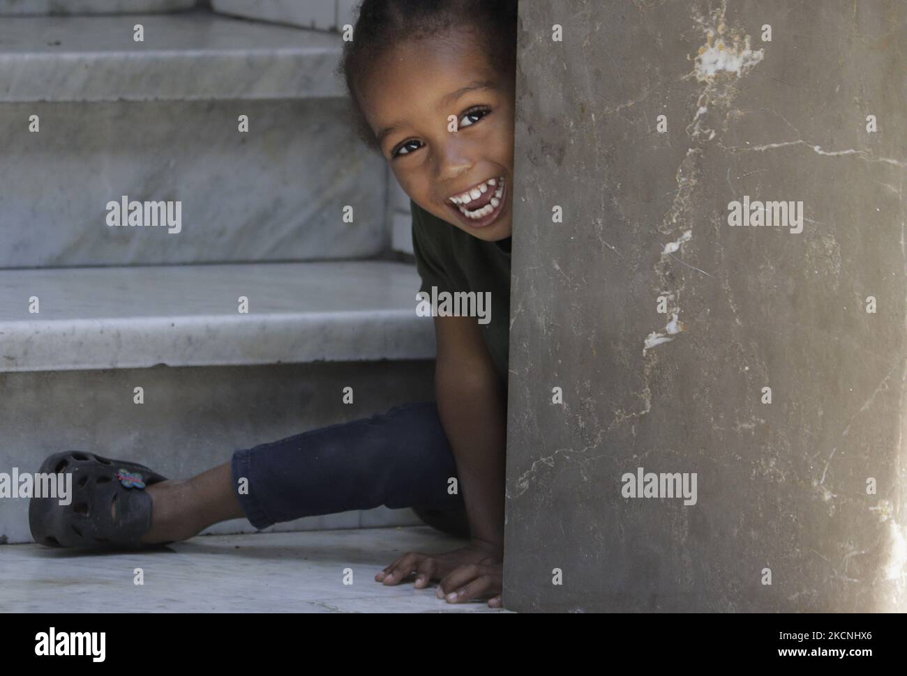 A Haitian migrant girl plays outside the Mexican Commission for Refugee Support in Mexico City, where more migrants recently went to various refugee support offices to try to obtain a procedure that would allow them to stay longer in Mexico in the face of the difficulties their compatriots are having in entering the United States during the COVID-19 health emergency. (Photo by Gerardo Vieyra/NurPhoto) Stock Photo