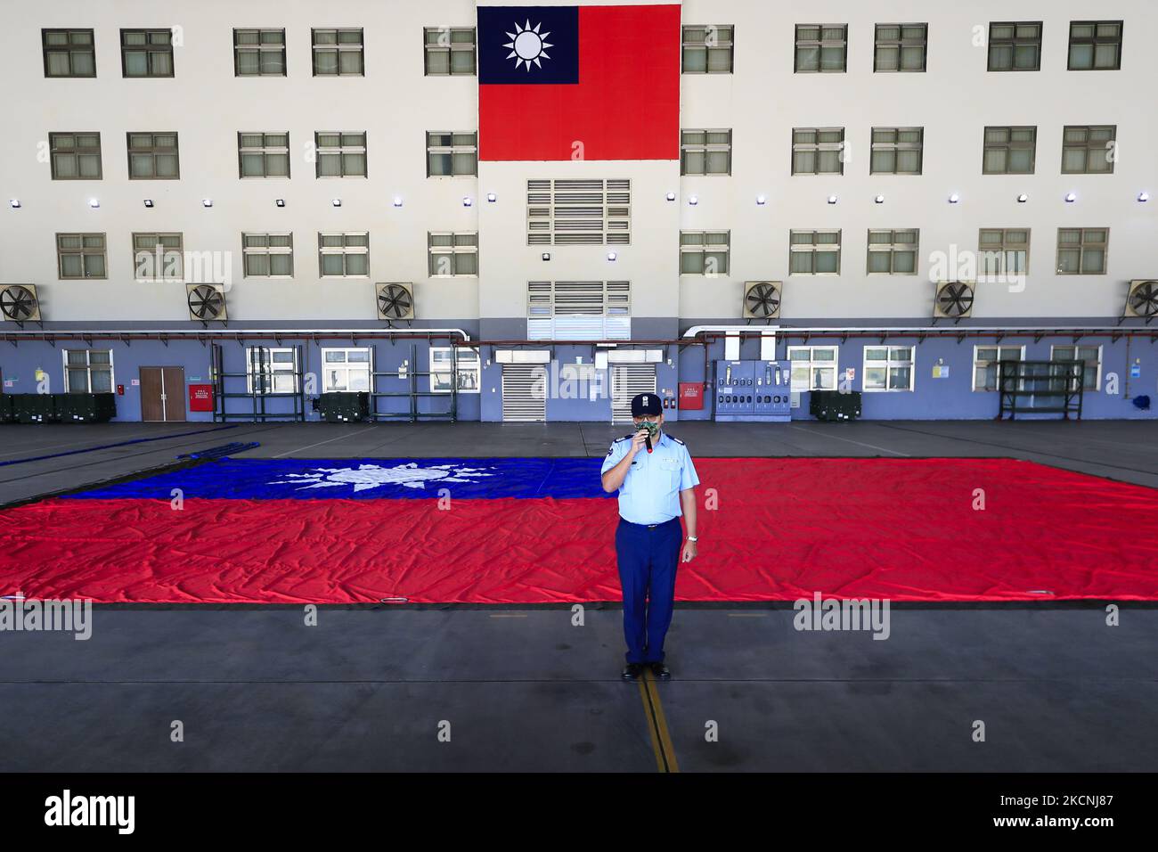 A tremendous Taiwan flag is displayed at a military camp, as part of a rehearsal for the flyby performance for Taiwan’s Double-Ten National Day Celebration, amid rising tensions between Beijing and Taipei and threats from China, in Taoyuan, Taiwan 28 September 2021. The 18-meter wide and 12-meter long Taiwan flag, according to state media Central News Agency, will be carried by two CH-47 Chinook helicopters flag flying over the Presidential Building on October 10, whilst the island has been developing better ties with the US, UK, Australia, and other European countries such as Lithuania, Czech Stock Photo