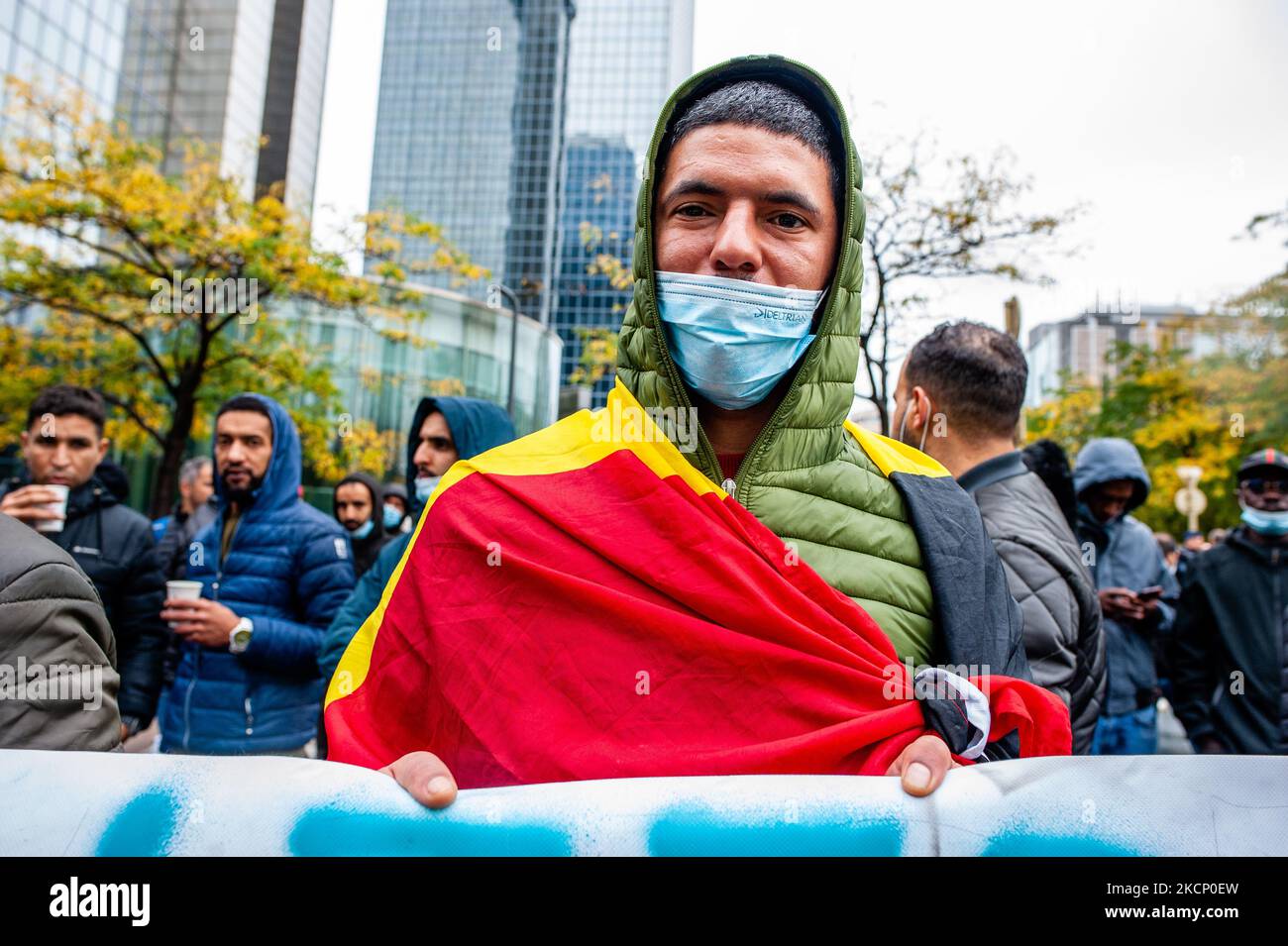 An immigrant without papers is wearing the Belgium flag, during 'We are Belgium too' demonstration organized in Brussels, on October 3rd, 2021. (Photo by Romy Arroyo Fernandez/NurPhoto) Stock Photo