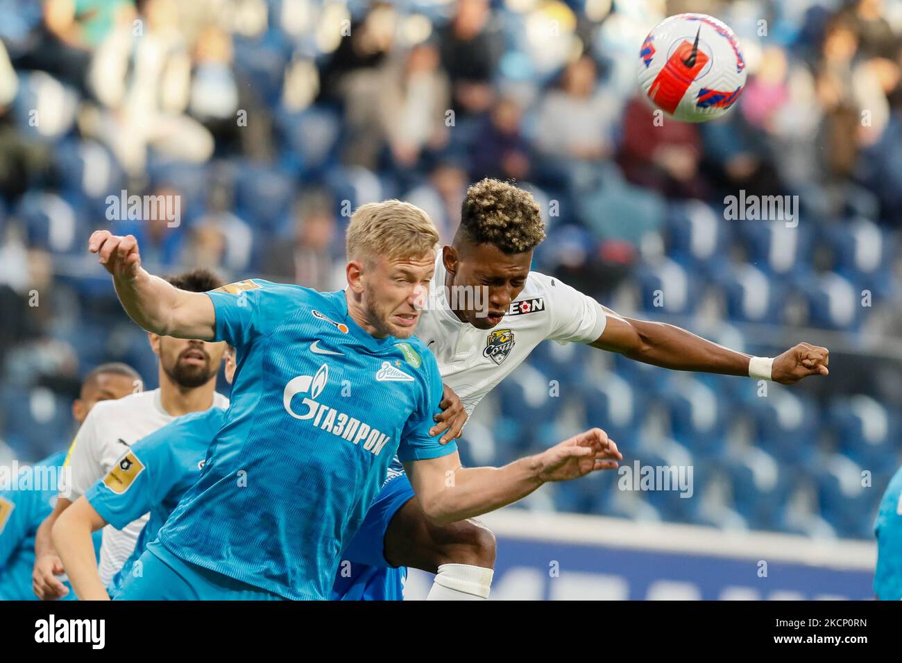Dmitri Chistyakov (L) of Zenit and Mateo Cassierra of Sochi vie for a header during the Russian Premier League match between FC Zenit Saint Petersburg and FC Sochi on October 3, 2021 at Gazprom Arena in Saint Petersburg, Russia. (Photo by Mike Kireev/NurPhoto) Stock Photo