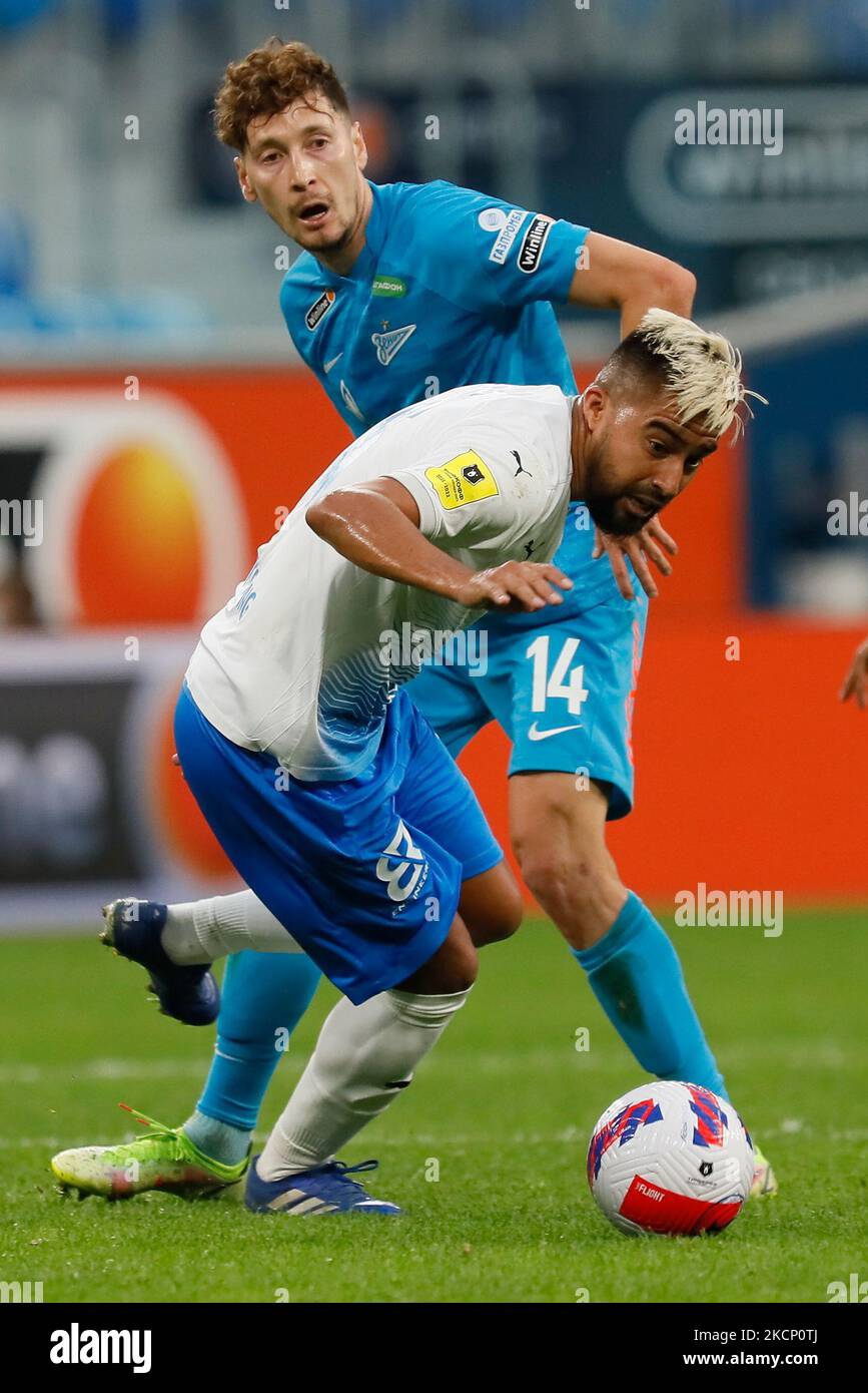 Daler Kuzyaev of Zenit and Christian Noboa (in front) of Sochi vie for the ball during the Russian Premier League match between FC Zenit Saint Petersburg and FC Sochi on October 3, 2021 at Gazprom Arena in Saint Petersburg, Russia. (Photo by Mike Kireev/NurPhoto) Stock Photo