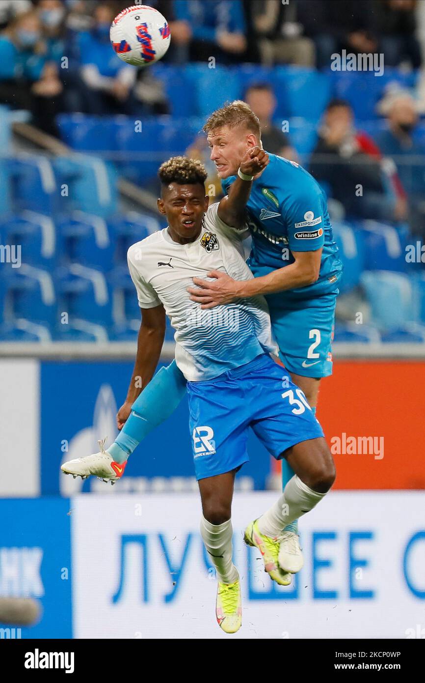 Dmitri Chistyakov (R) of Zenit and Mateo Cassierra of Sochi vie for a header during the Russian Premier League match between FC Zenit Saint Petersburg and FC Sochi on October 3, 2021 at Gazprom Arena in Saint Petersburg, Russia. (Photo by Mike Kireev/NurPhoto) Stock Photo