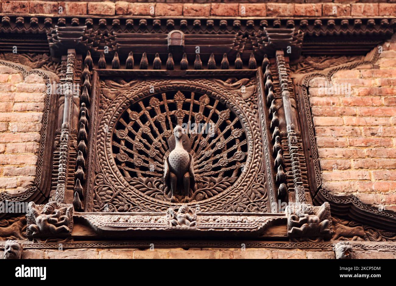 Peacock window at Pujari Math in the ancient city of Bhaktapur, Nepal, on December 08, 2011. The peacock window dates back to the early 15th century and is a very famous example of the workmanship that can be seen throughout much of Nepal. (Photo by Creative Touch Imaging Ltd./NurPhoto) Stock Photo