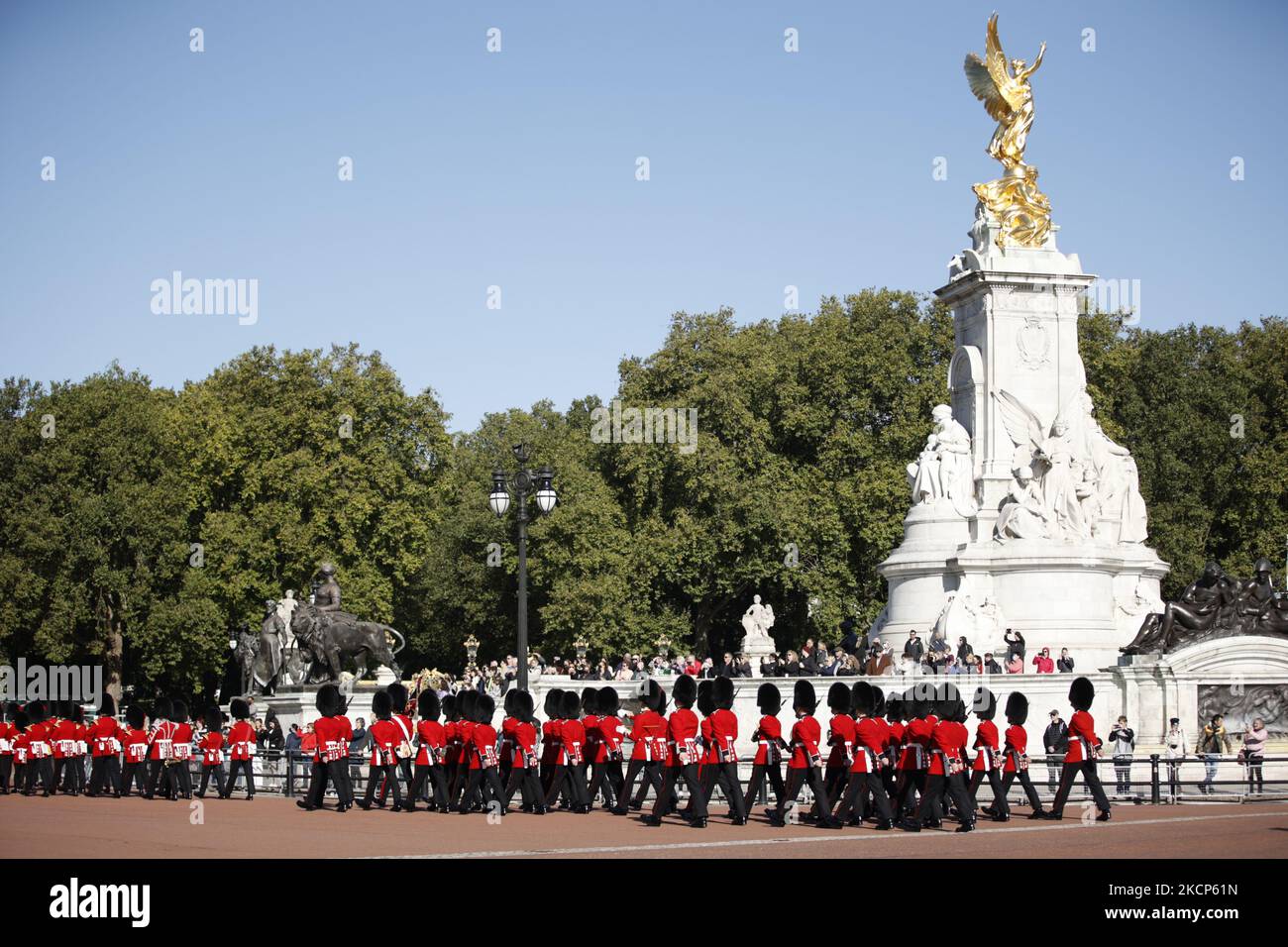 Members of the Coldstream Guards regiment of the British Army Household Division march from Wellington Barracks past the Victoria Memorial on their way into Buckingham Palace to replace members of the Royal Regiment of Canadian Artillery as the Canadian soldiers take part in their first Changing of the Guard 'dismount' from duty in London, England, on October 6, 2021. Ninety Canadian personnel are carrying out Queen's Guard duties at the four residences of the Royal Family in London (Buckingham Palace, St James's Palace, Windsor Castle and the Tower of London) from October 4-22. For the mount  Stock Photo