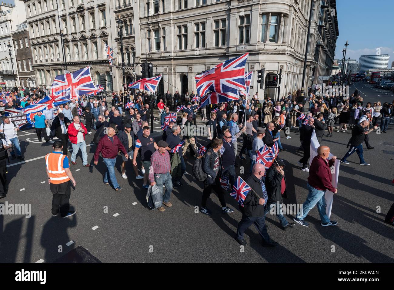 LONDON, UNITED KINGDOM - OCTOBER 09, 2021: Northern Ireland unionists and loyalists march along Whitehall in a protest against the Northern Ireland Protocol, which they argue undermines Northern Ireland's position as part of the United Kingdom by creating a trade border on the Irish Sea on October 09, 2021 in London, England. Next week, the EU is set to bring forward new proposals for the Northern Ireland Protocol, which was implemented after Brexit to protect the Good Friday agreement by keeping Northern Ireland aligned with the EU's single market for goods to prevent creating a hard border o Stock Photo