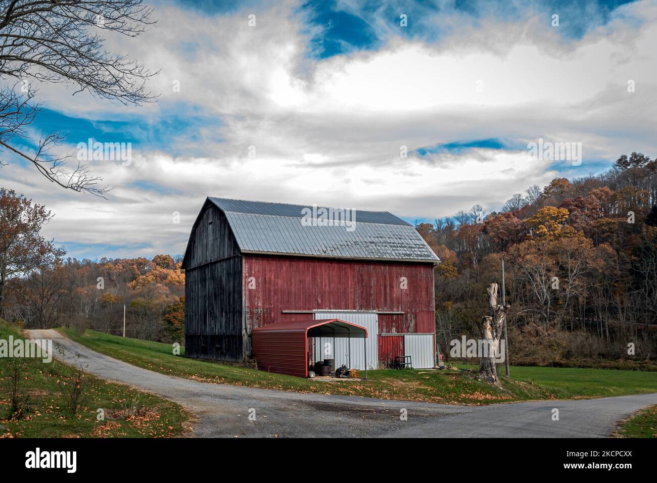 Old weathered red barn in rural Appalachia on a cloudy autumn day Stock