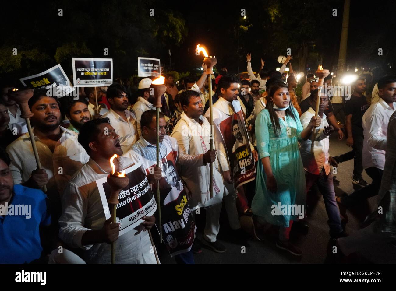Activists of the Indian Youth Congress (IYC) party hold torches as they shout slogans during a protest against killing of four farmers in Uttar Pradesh's Lakhimpur Kheri after being run over by a car owned by India's Union Minister of State for Home, in New Delhi, India on October 13, 2021. (Photo by Mayank Makhija/NurPhoto) Stock Photo