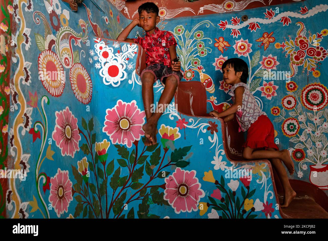 Children play inside a colorfully painted house in alpona village in chapainawabganj, Bangladesh. (Photo by Mushfiqul Alam/NurPhoto) Stock Photo