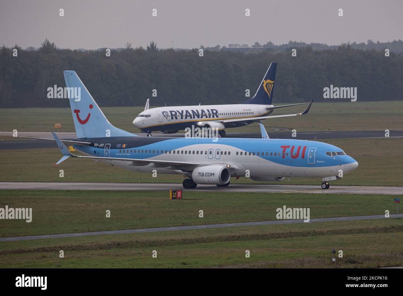 A TUI and a Ryanair Boeing 737 aircraft taxiing. TUI Airlines Belgium Boeing 737-800 aircraft as seen flying, landing and taxiing at Eindhoven Airport EIN EHEH. The airplane arrived from Oujda Morocco, has the registration OO-JAY and the name Elegance. TUI fly former Jetairfly is a Belgian scheduled and charter airline, subsidiary of TUI Group, the German multinational travel and tourism company, largest leisure company in the world, and TUI airlines. Eindhoven, the Netherlands on October 15, 2021 (Photo by Nicolas Economou/NurPhoto) Stock Photo