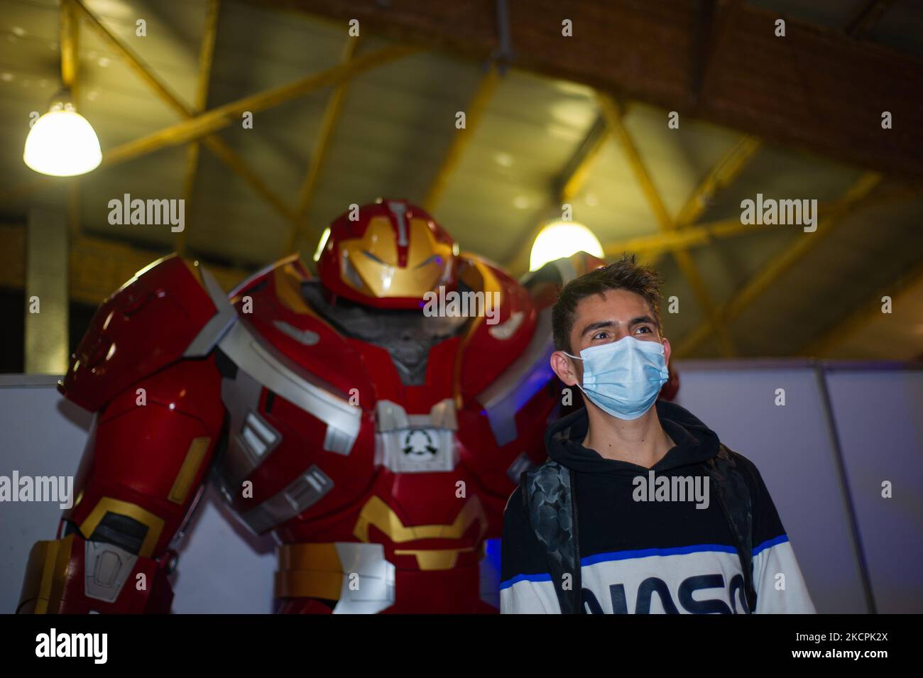 An attendee takes a photo with an Marvel Comics Iron Man suit during the first day of the SOFA (Salon del Ocio y la Fantasia) 2021, a fair aimed to the geek audience in Colombia that mixes Cosplay, gaming, superhero and movie fans from across Colombia, in Bogota, Colombia on October 14, 2021. (Photo by Sebastian Barros/NurPhoto) Stock Photo