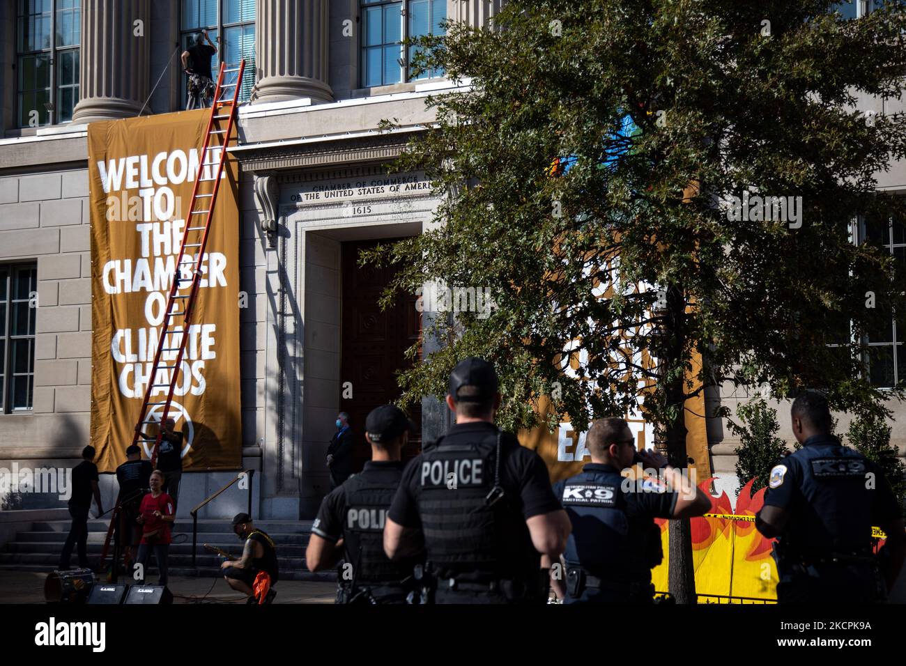 Police wait to arrest an environmental activist as the demonstrator ...