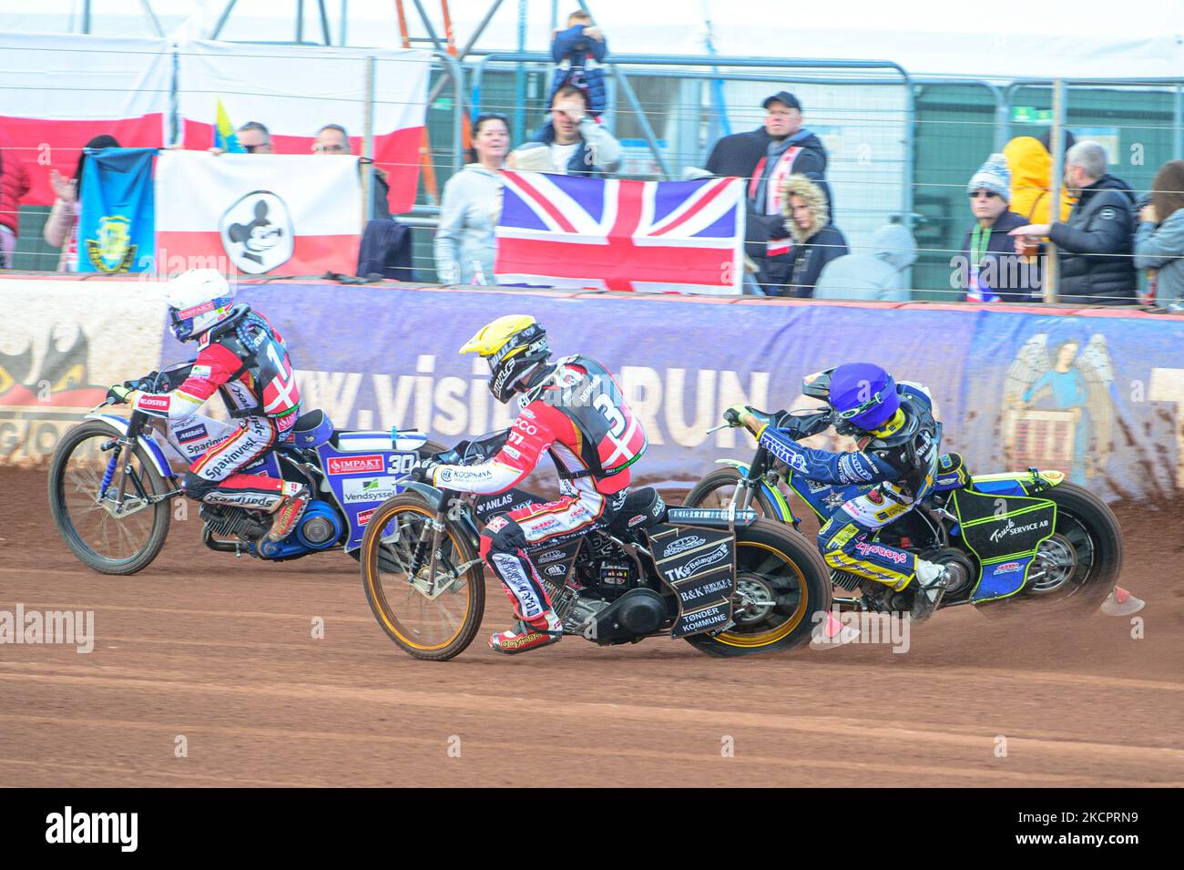 Leon Madsen of Denmark (White) leads as Mads Hansen of Denmark (Yellow)  passes Philip Hellström-Bangs of Sweden (Blue) during the Monster Energy  FIM Speedway of Nations at the National Speedway Stadium, Manchester