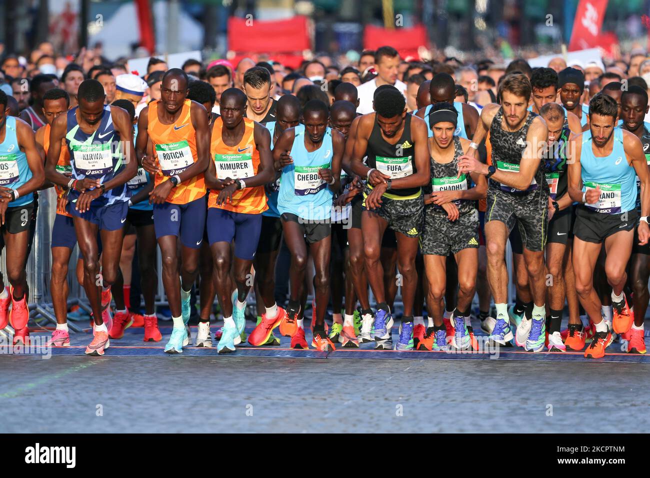 Kenya s Elisha Rotich 3L winner in the men s race takes the