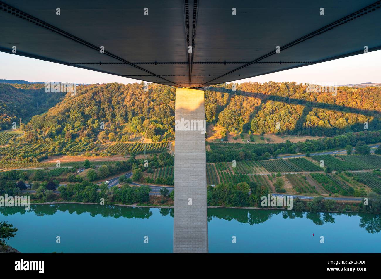 Underneath the A61 Moseltal bridge during sunrise with a view down to the Mosel river and vineyards in the valley near Koblenz in Rhineland-Palatinate Stock Photo