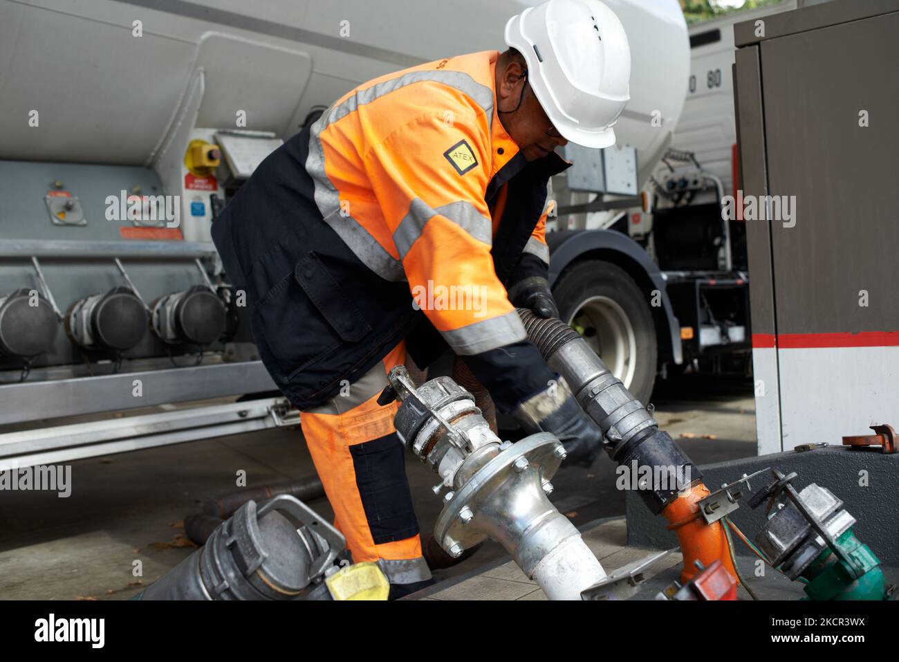 An employee prepares to refill a gas station in Toulouse. The French