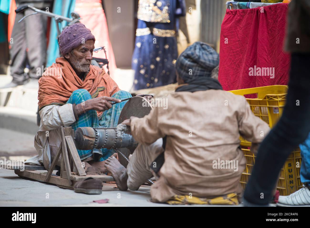 Kathmandu, Nepal- April 20,2019 : Knife sharpeners sharpen knives on the streets of Kathmandu in the traditional way. Stock Photo