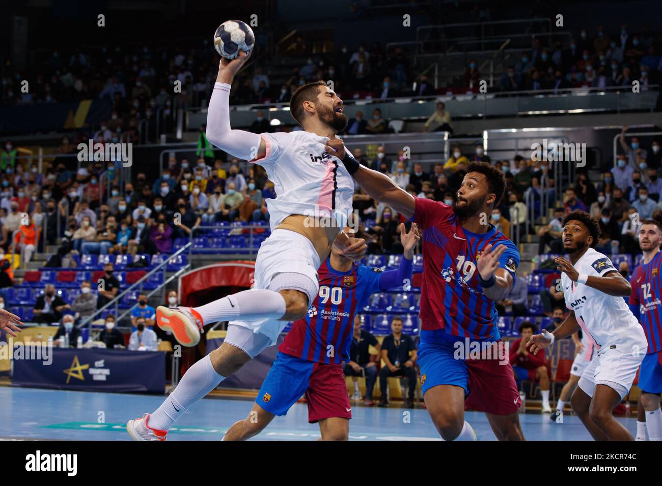 Nikola Karabatic of PSG Handball in action with Timothey Nguessan of FC  Barcelona during the EHF Champions League match between FC Barcelona and PSG  Handball at Palau Blaugrana in Barcelona. (Photo by