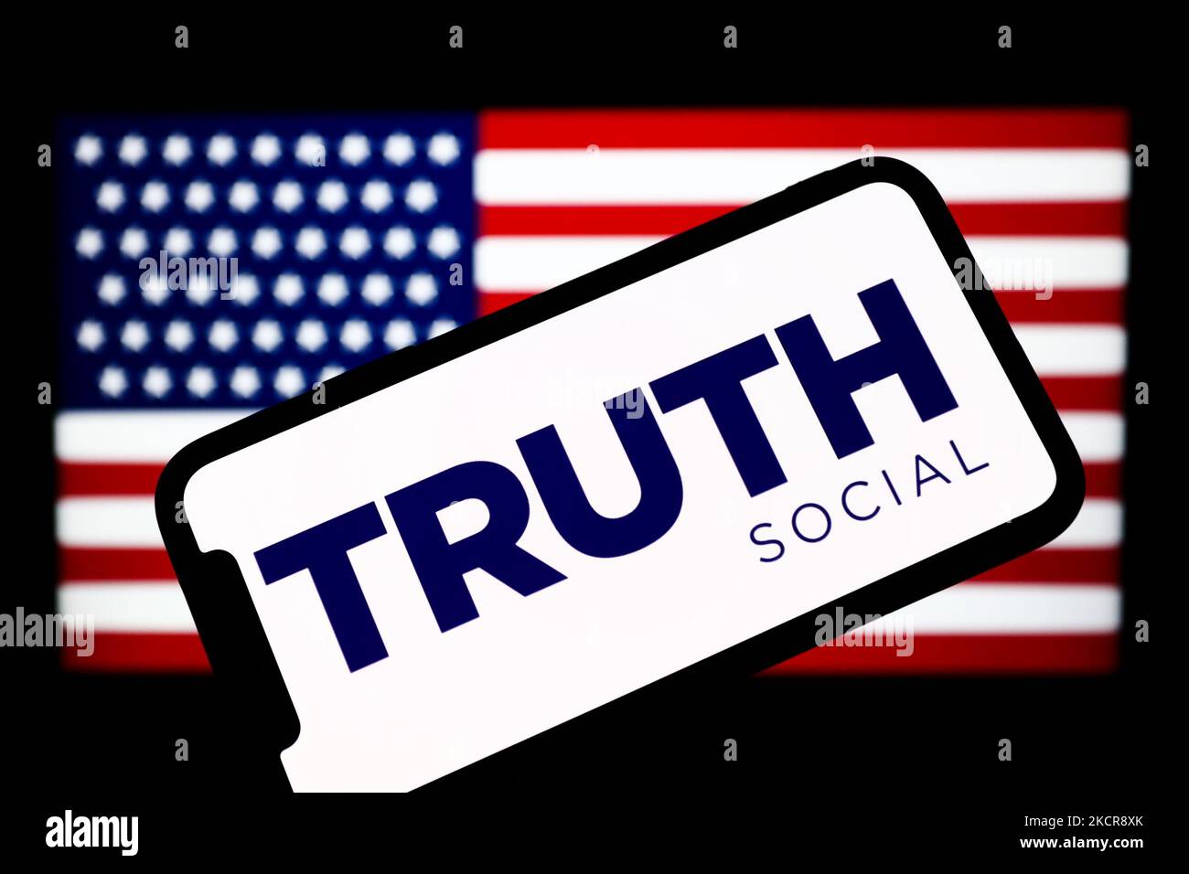 TRUTH Social logo is seen displayed on a phone screen with Amercan flag(05)