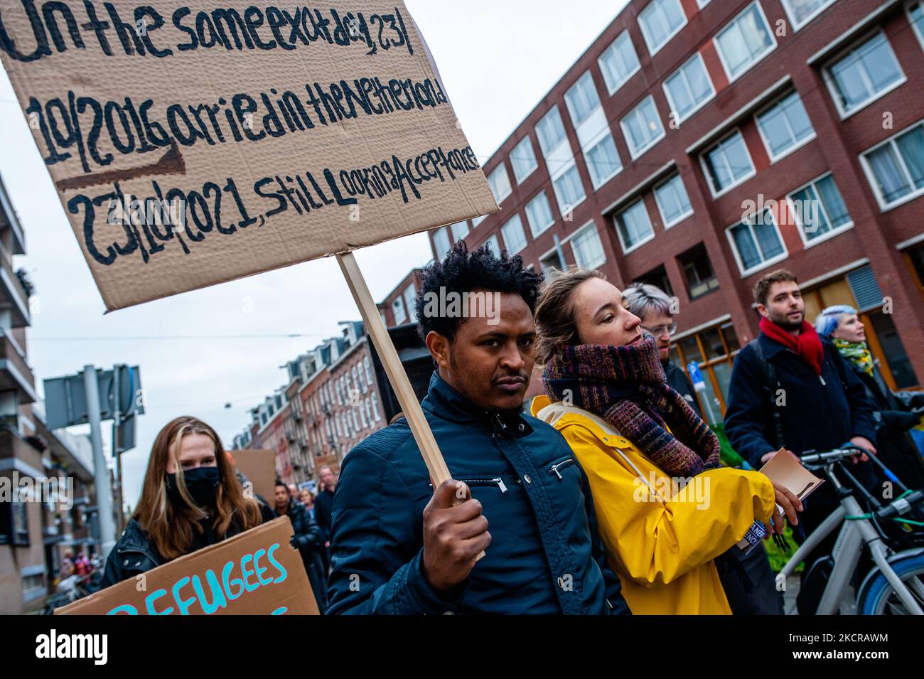 An undocumented man is holding a placard asking for a solution, during a demonstration organized by the group 'We Are Here' to demand permanent residency, in Amsterdam, on October 23rd, 2021. (Photo by Romy Arroyo Fernandez/NurPhoto) Stock Photo