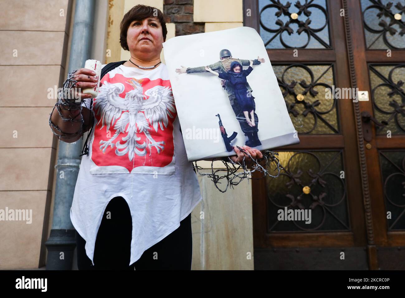 A woman holds a banner during 'Stop Tortures at the Border' protest in solidarity with refugees stuck at Polish-Belarusian border. Krakow, Poland on October 17, 2021. Poland has declared State of Emergency on the border with Belarus. Groups of migrants are being pushed back to Belarus by the Polish border guards after attempting to enter Poland. No media or humanitarian and medical aid are allowed to enter the border zone. (Photo by Beata Zawrzel/NurPhoto) Stock Photo