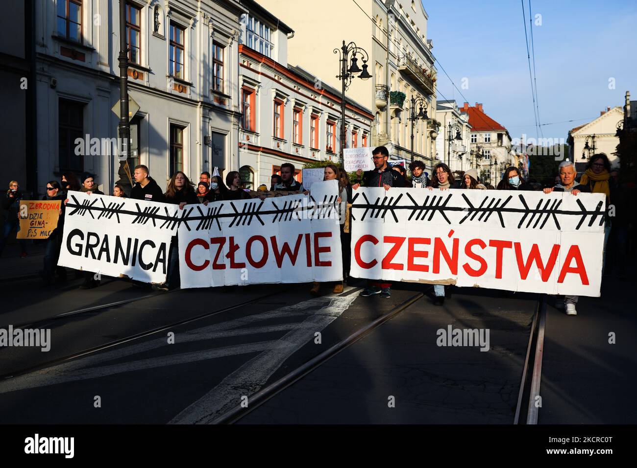 People hold a banner 'The Border of Humanity' during 'Stop Tortures at the Border' protest in solidarity with refugees stuck at Polish-Belarusian border. Krakow, Poland on October 17, 2021. Poland has declared State of Emergency on the border with Belarus. Groups of migrants are being pushed back to Belarus by the Polish border guards after attempting to enter Poland. No media or humanitarian and medical aid are allowed to enter the border zone. (Photo by Beata Zawrzel/NurPhoto) Stock Photo