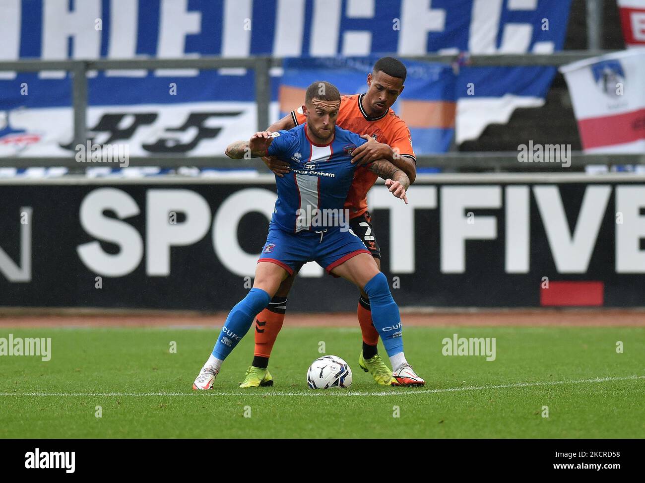 Oldham Athletic's Jordan Clarke tussles with Lewis Alessandra of Carlisle United during the Sky Bet League 2 match between Carlisle United and Oldham Athletic at Brunton Park, Carlisle on Saturday 23rd October 2021. (Photo by Eddie Garvey/MI News/NurPhoto) Stock Photo