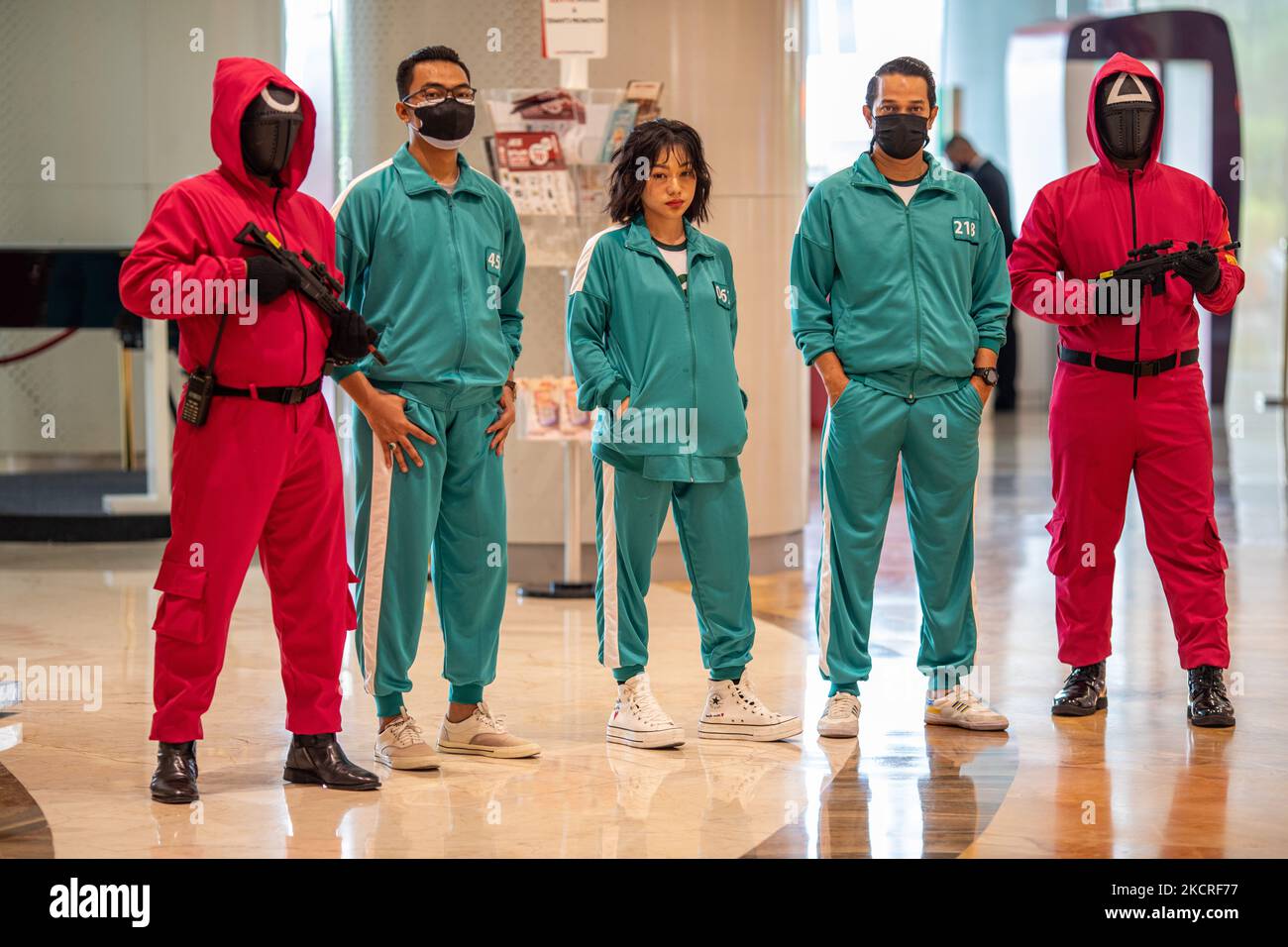 The employees and security of this mall are wearing ''Squid Game'' costumes, in Jakarta, Indonesia, on October 24, 2021. The use of this costume attracts many people to visit the mall. (Photo by Donal Husni/NurPhoto) Stock Photo