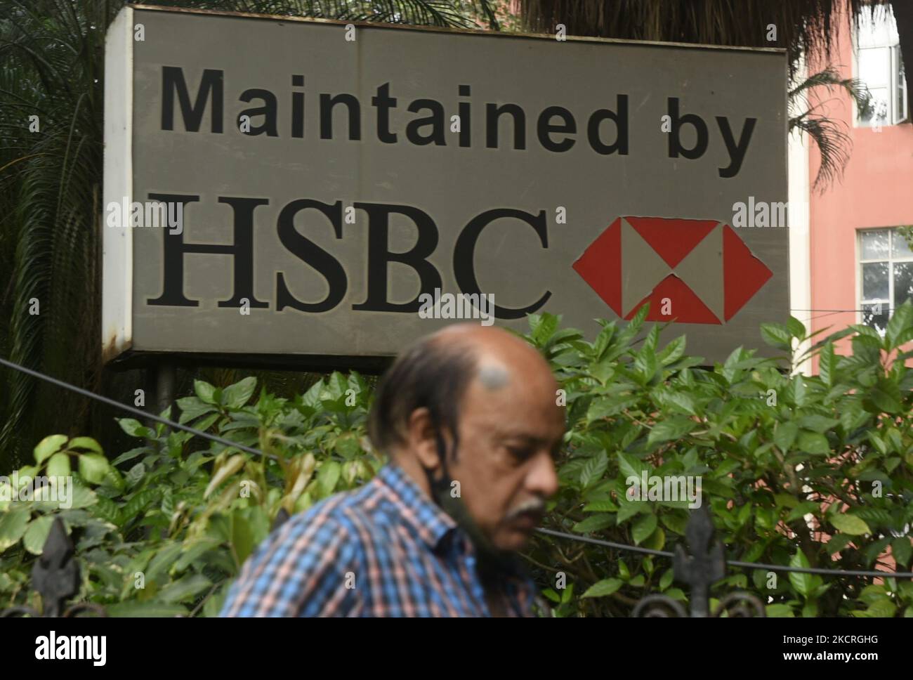 A man crosses HSBC logo in Kolkata, India, 25 October, 2021. HSBC’s profits rose 74% in the third quarter as improving economic conditions allowed the bank to release hundreds of millions of pounds originally set aside for a potential jump in loan defaults during the pandemic according to an Indian media report. (Photo by Indranil Aditya/NurPhoto) Stock Photo