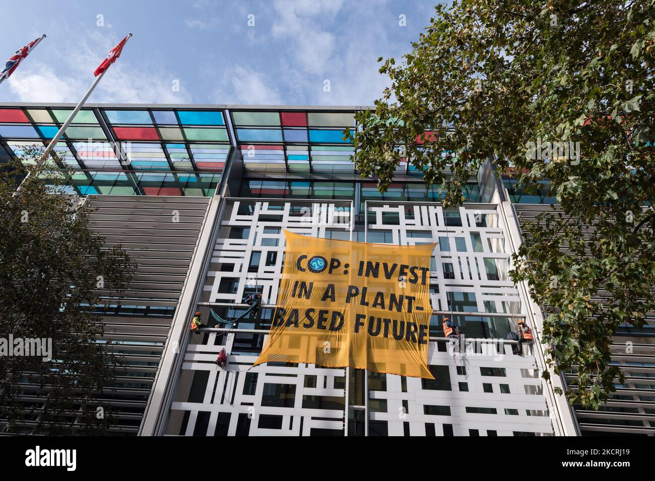 LONDON, UNITED KINGDOM - OCTOBER 26, 2021: Activists from Animal Rebellion scaled the outside of the building of the Department for Environment, Food and Rural Affairs (Defra) and dropped a banner calling on the UK Government to invest in transition to a plant-based food system in the run-up to the COP26 UN Climate Change Conference in Glasgow, which begins on Sunday, on October 26, 2021 in London, England. (Photo by WIktor Szymanowicz/NurPhoto) Stock Photo