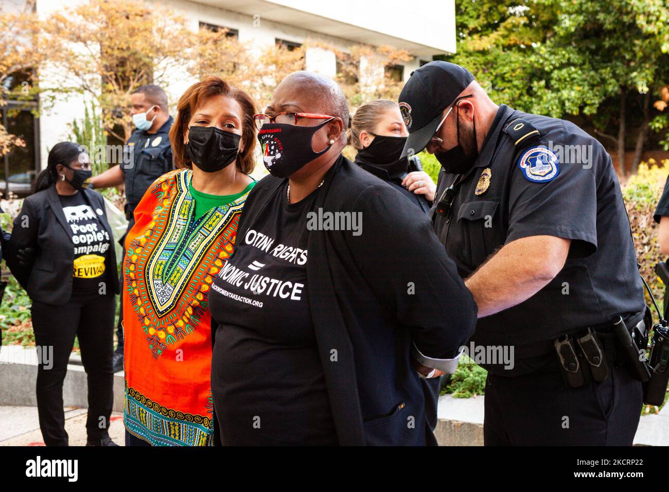 Deborah Scott (left) of Georgia STAND-UP waits while a Capitol Police officer adjusts the handcuffs on Melanie Campbell (center), president and CEO of the Black Women’s Roundtable, following arrest in a civil disobedience action for for voting rights and economic justice. Protesters are demanding that Congress to pass legislation protecting the right to vote and providing economic assistance to Americans. Specifically, they want passage of the Freedom to Vote Act, the Build Back Better Act, and the Infrastructure Investment and Jobs Act. (Photo by Allison Bailey/NurPhoto) Stock Photo
