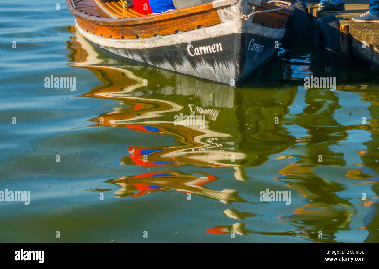 Boat and reflections on water. Stock Photo