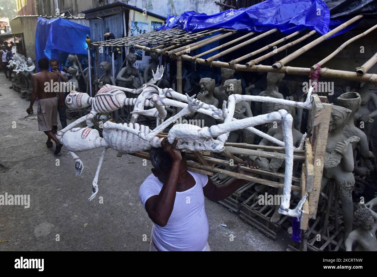 A worker carries skeleton structure for pandal decoration of the upcoming Kali puja festival in Kolkata, India, 30 October, 2021. Goddess Kali is being worshipped as a saviors from all evil forces, demons and a source of Power, Happiness as per Hindu Mythology. (Photo by Indranil Aditya/NurPhoto) Stock Photo