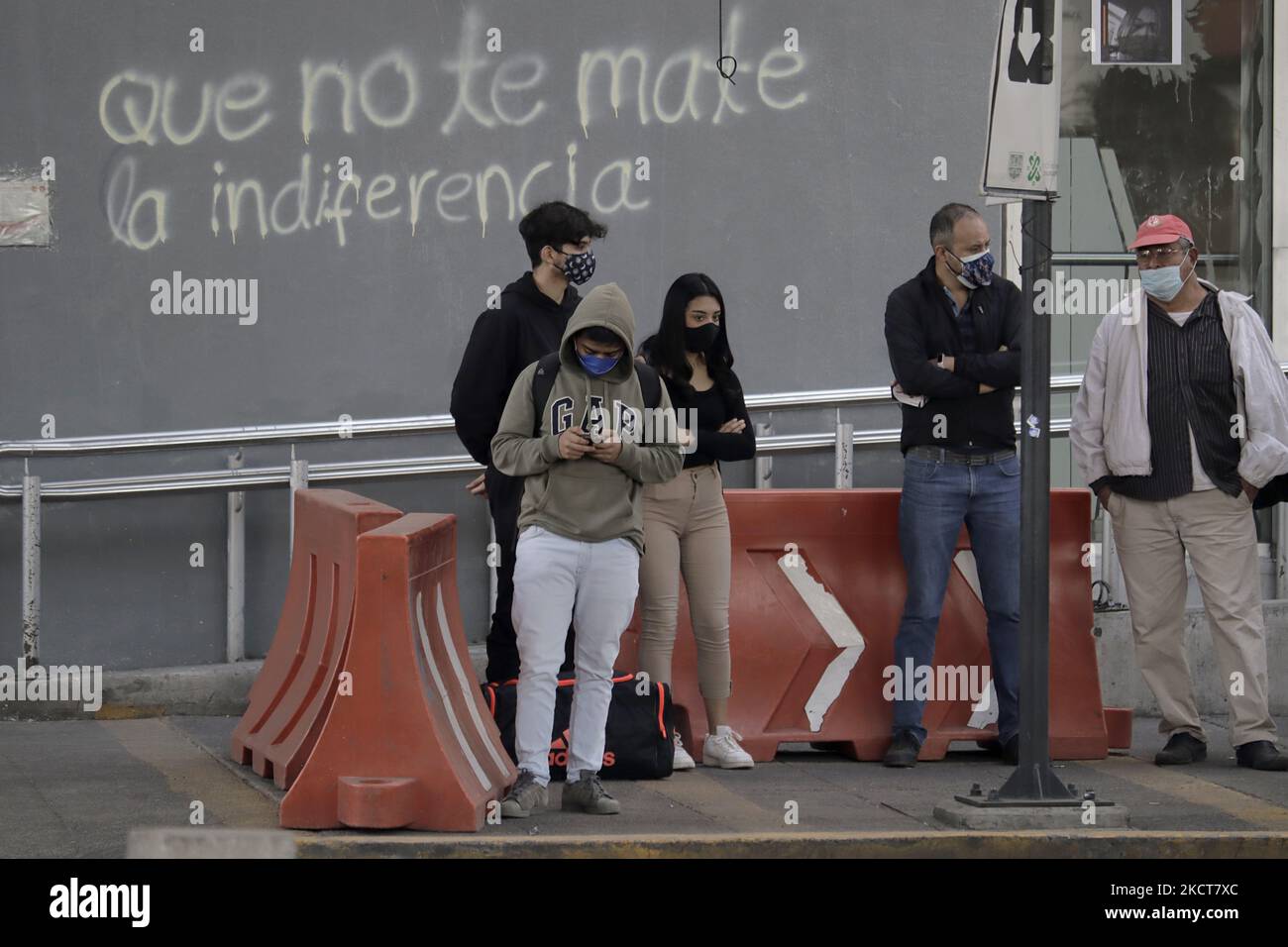 a-group-of-people-stand-outside-the-olivos-metro-station-line-12-six