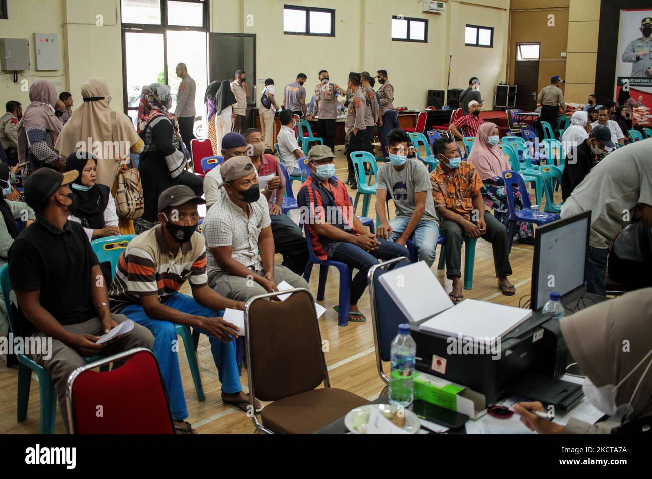 People are seen waiting for their turn to get the Moderna vaccine