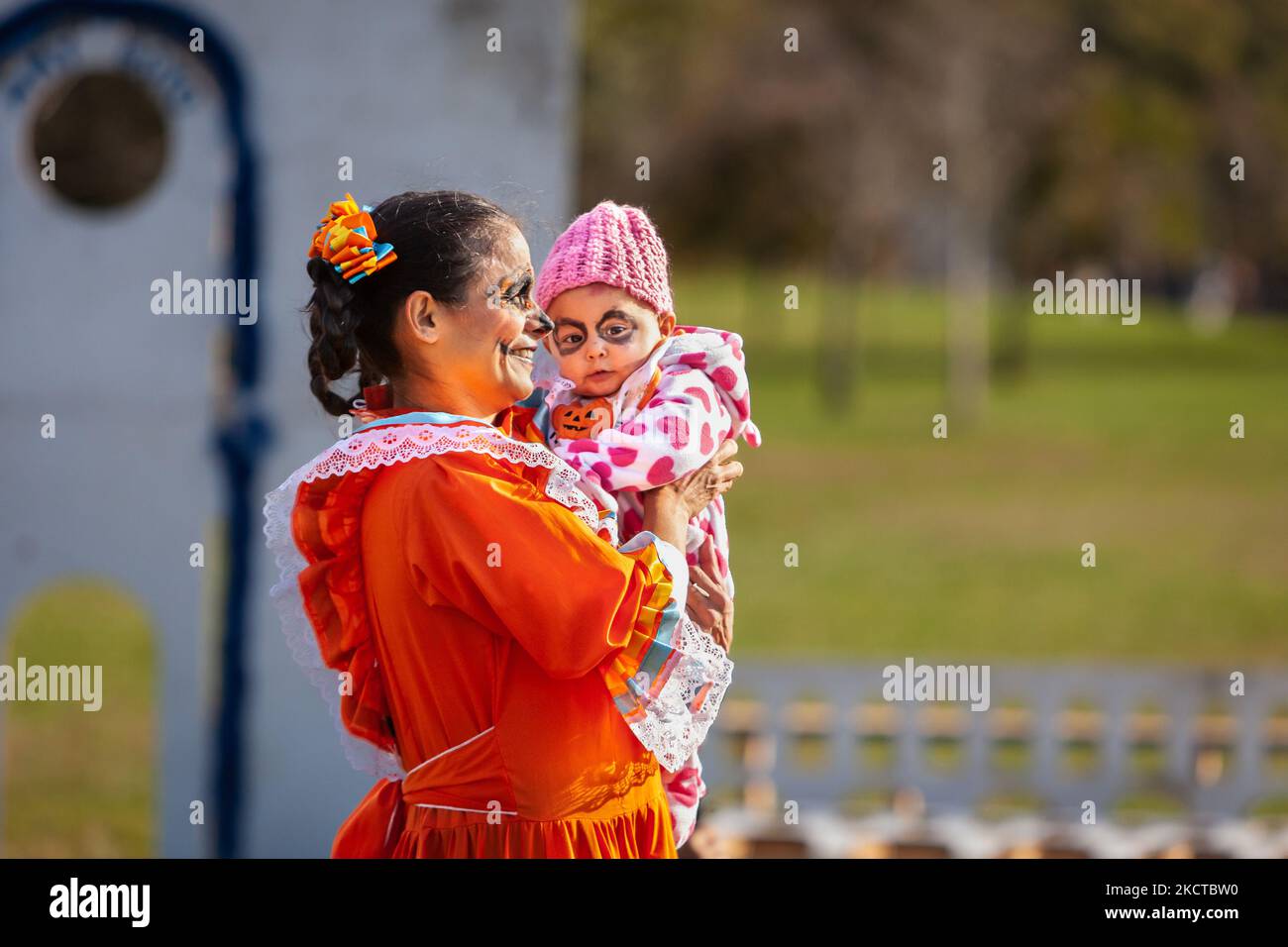 A mother and baby dance to the music of a mariachi band at the Día de los Muertos benefit and festival on the National Mall. In addition to celebrating the holiday, the festival has two additional purposes: federal recognition of Día de los Muertos as an important cultural day and fundraising for organizations that reunite families separated at the border by US Immigration and Customs Enforcement (ICE). (Photo by Allison Bailey/NurPhoto) Stock Photo