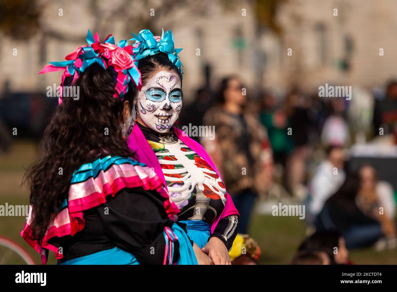 Two women dressed as Catrinas - the skeletal figure associated with the Día de Los Muertos - attend a benefit and festival on the National Mall in celebration of the holiday. In addition to celebrating the holiday, the festival has two additional purposes: federal recognition of Día de los Muertos as an important cultural day and fundraising for organizations that reunite families separated at the border by US Immigration and Customs Enforcement (ICE). (Photo by Allison Bailey/NurPhoto) Stock Photo